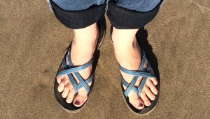 sandal feet on the beach