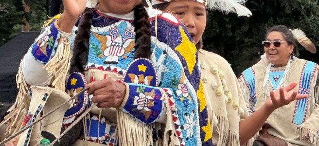 Umatilla Indians in beaded regalia riding a horse