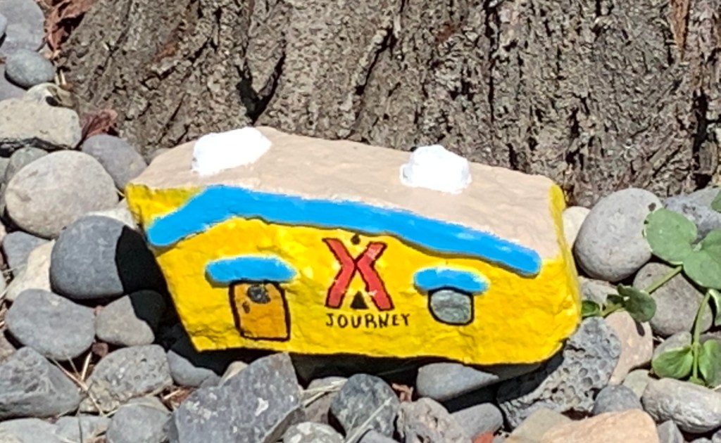 rock painted to resemble an RV in KOA yellow with the KOA campground logo