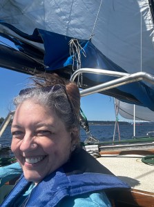 author on her sailboat under sail