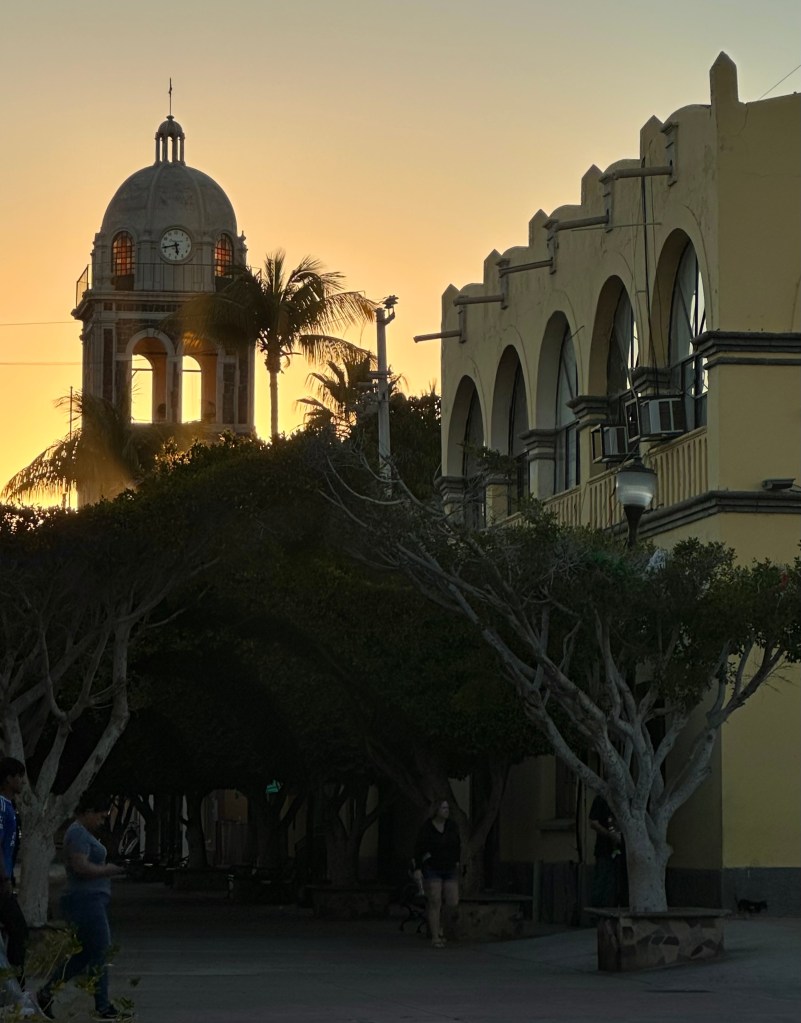 Mexican church tower against a sunset sky