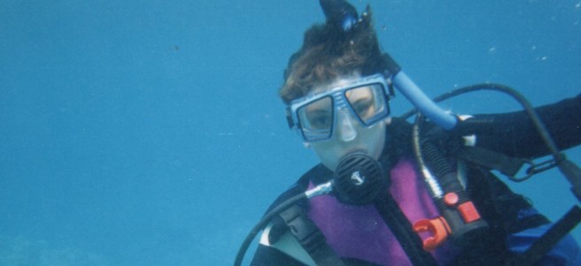 writer underwater in SCUBA gear