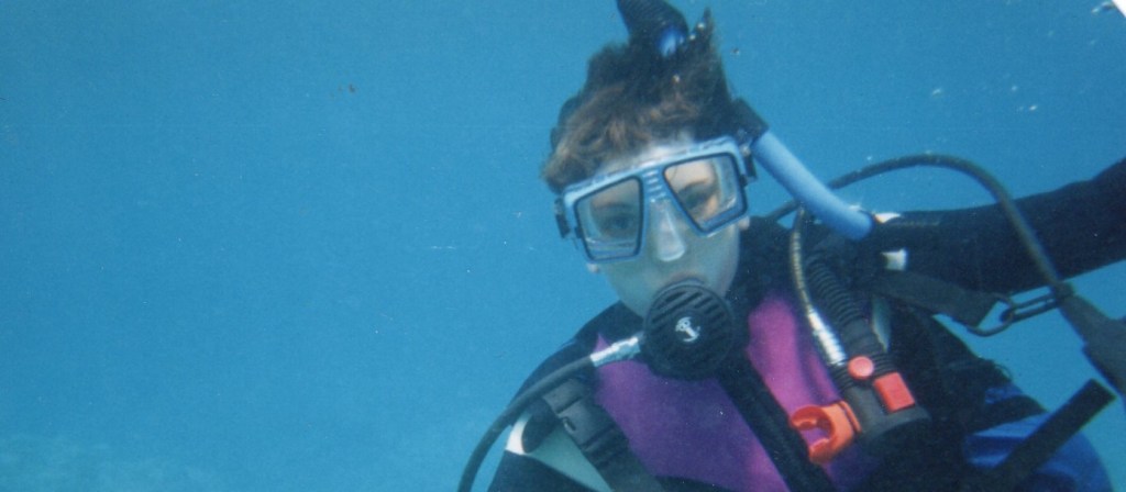 writer underwater in SCUBA gear