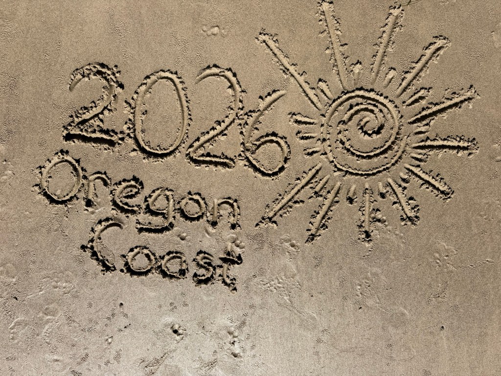 "2026 Oregon Coast" written in sand